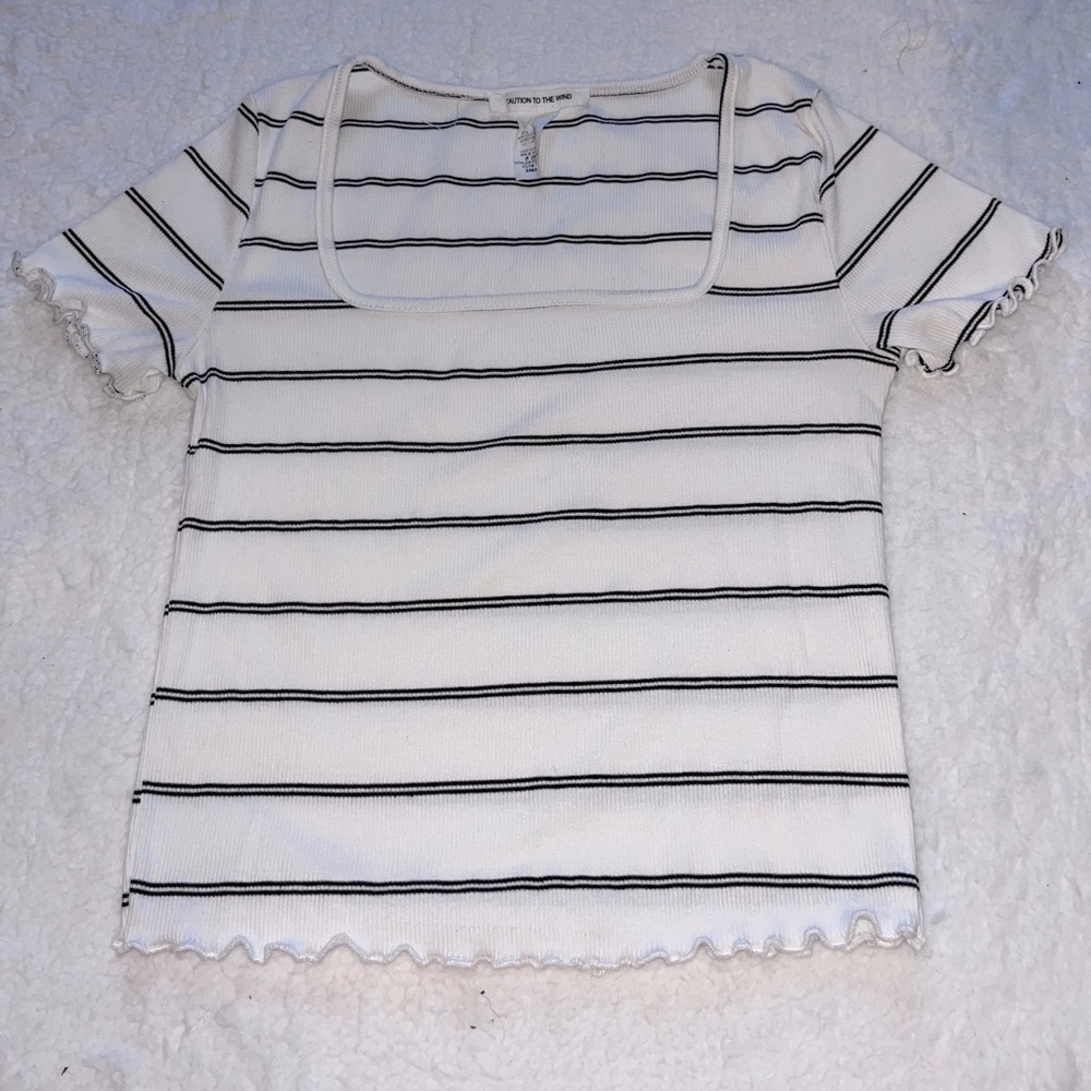 White and black striped t-shirt with ruffled sleeves.